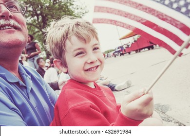 Boy and his father watching a parade