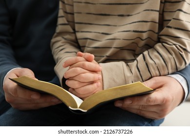 Boy And His Godparent Reading Bible Together, Closeup