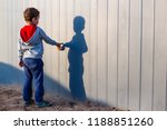 boy and his shadow. Lonely little child playing with his shadow outside. the concept of autism and loneliness. Copy space for your text