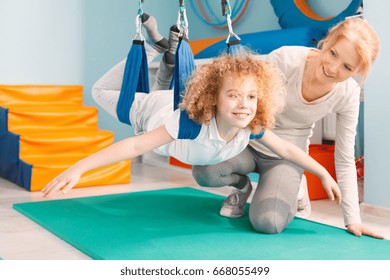 Boy And His Therapist Exercising During Sensory Integration Therapy 