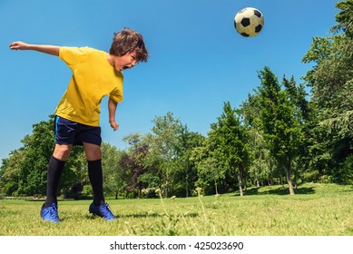 Boy Hits A Soccer Ball With Head In The Park