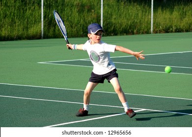 boy hitting forehand in tennis