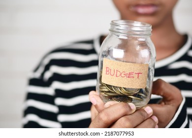 Boy Holding A Coin Jar With Budget Text 