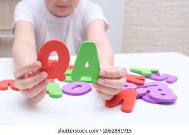 A Boy Holding Colorful Letters Q And A, Questions And Answers Concept, Solvation Kids Problems