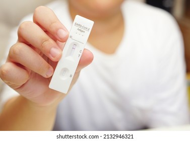 A Boy Holding Covid-19 Negative Test Result With SARS CoV-2 Rapid Antigen Test Kit (ATK), Preliminary Emergency Medical Screening.