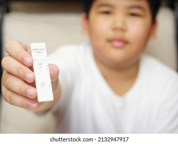 A Boy Holding Covid-19 Negative Test Result With SARS CoV-2 Rapid Antigen Test Kit (ATK), Preliminary Emergency Medical Screening.