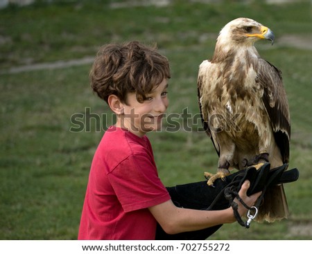 boy holding a eagle, Show falconry
