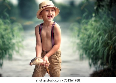 The Boy Is Holding A Fish