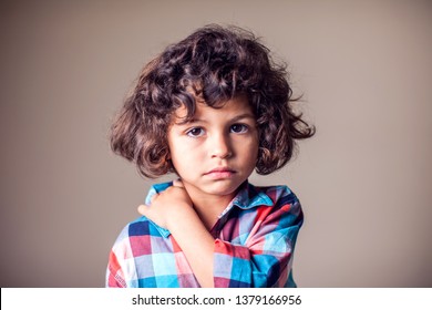 A boy holding his painful neck. Children, healthcare, medicine concept - Powered by Shutterstock