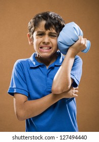 Boy Holding Ice Pack To His Head And Suffering