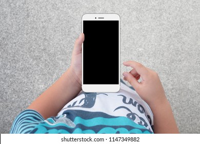 Boy Holding Phone With Empty Black Screen, Top View. Kid Play Game, Surfing Online, Learning...etc. Mockup