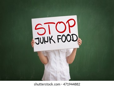 Boy holding a sign with no junk food text 