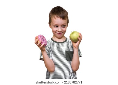 The Boy Holds A Donut And An Apple In His Hands On A White Background. Child Food Choice Fruit Or Sweet Donut.