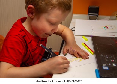 The Boy At Home At The Table Draws A Picture. The Kid Stuck Out His Tongue In Exertion. Wicked, Smart Kid.