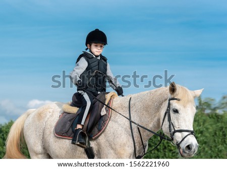 Boy horseback riding at ranch