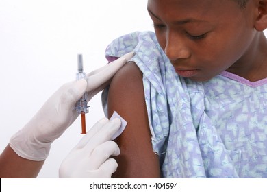 Boy In Hospital Gown About To Get An Injection.