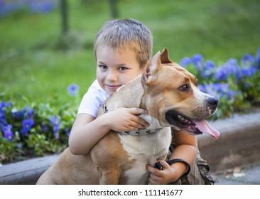 Boy Hug The Dog. Family And Pet Concept