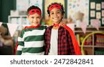 Boy, hug and portrait of children with costume in classroom for halloween, fantasy dress up or cosplay. Kindergarten, friends and happy kids with smile for superhero outfit, sidekick or support