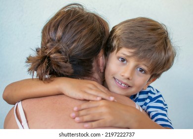 Boy Hugs His Grandmother. Smiling Child Giving A Hug. Human Contact