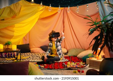 The Boy Are Inside A Massive And Brightly Colored Indoor Blanket Fort While Playing Together With A Vr Headset