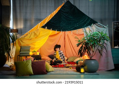 The Boy Are Inside A Massive And Brightly Colored Indoor Blanket Fort While Playing Together With A Vr Headset