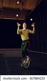 Boy Juggling And Riding Unicycle