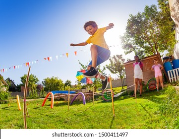 Boy jump over strings passing course of obstacles - Powered by Shutterstock