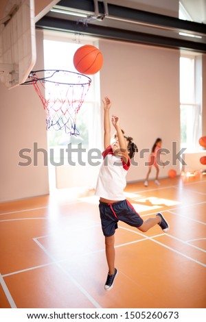 Boy jumping high. Boy jumping high while training and playing basketball at PE lesson