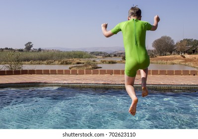 boy jumping into pool