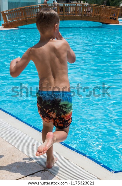 Boy Jumping Into Pool Stock Photo Edit Now 1175323021