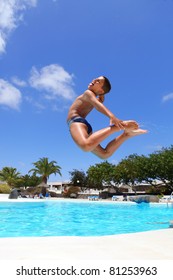 Boy Jumping Into The Pool Smiling