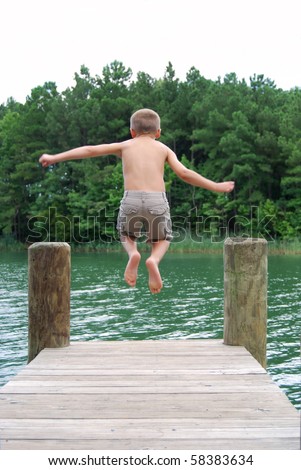 boy jumping off dock