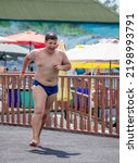 The boy jumps into the pool with a run. Aquapark