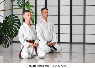 Boy And Karate Instructor In Dojo