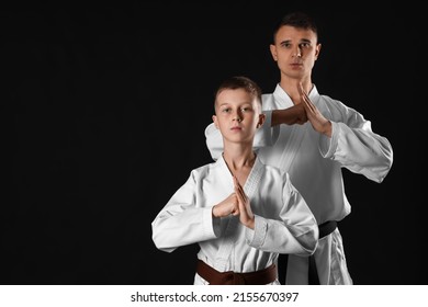 Boy With Karate Instructor On Dark Background