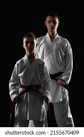 Boy With Karate Instructor On Dark Background