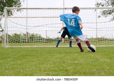 boy kicking a penalty at goal