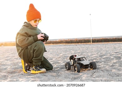 Boy Kid Playing Radio Control Car Riding On Sand Outdoor Enjoying Happy Childhood