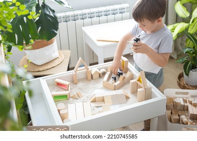 Boy Kid Playing Sensory Box Kinetic Sand Table With Montessori Wooden Materials And Farm Animals Closeup. Happy Baby Child Enjoy Childhood Early Development At Room With Wigwam Camping