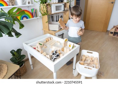 Boy Kid Playing Sensory Box Kinetic Sand Table With Montessori Wooden Materials And Farm Animals Closeup. Happy Baby Child Enjoy Childhood Early Development At Room With Wigwam Camping