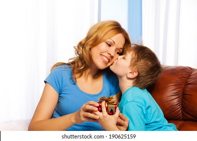 Boy Kisses His Mother In Cheek When Giving Gift