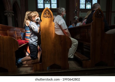 Boy Kneeling Down And Prays In The Church