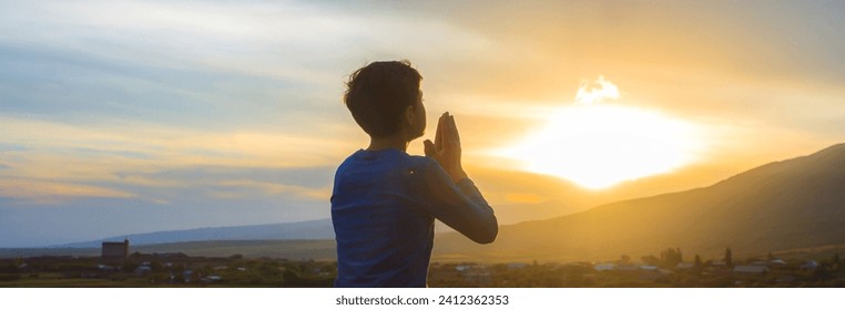 A boy kneeling and praying - Powered by Shutterstock