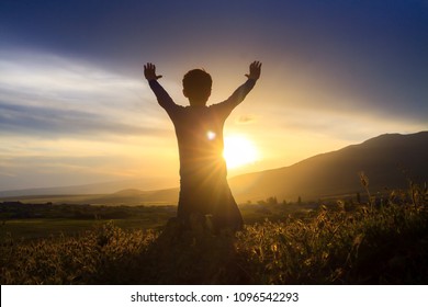 A boy kneeling and worshiping - Shutterstock ID 1096542293
