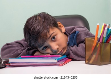 a boy laying down on table and looking at camera