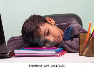 a boy laying down on table and thinking