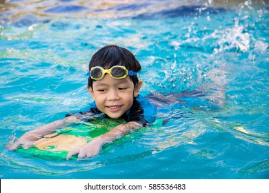 boy learn to swim in the swimming pool