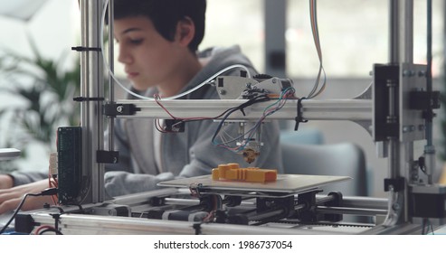 Boy Learning 3D Printing At Home, Professional 3D Printer On The Foreground