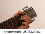 boy learning to play guitar, young guitarist, guitar practice, music lesson, beginner guitarist, teenager with guitar, acoustic guitar, music education, learning an instrument, boy playing 