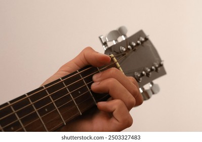 boy learning to play guitar, young guitarist, guitar practice, music lesson, beginner guitarist, teenager with guitar, acoustic guitar, music education, learning an instrument, boy playing  - Powered by Shutterstock